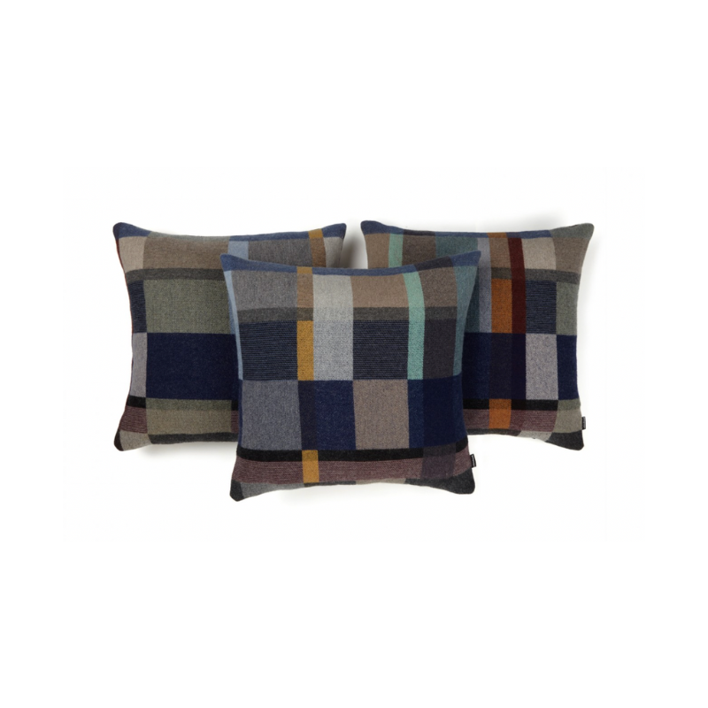 This stunning throw pillow features a bold checkerboard pattern of juxtaposed blocks and striking hues. Made from sumptuous merino lambswool, is cushion reversible with a different colorway on each side. 