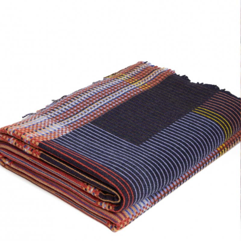 The Calvert Throw by Wallace & Sewell is made of woven merino lambswool. The Pinstripe collection combines bold-colored blocks with fine, detailed vertical stripes. This double-sided design also has a contrasting pixelated border and is a stunning room addition. Materials: 100% merino lambswool, from Australia and South Africa. Dyed and spun in Yorkshire, UK. Fabric is woven in Lancashire, UK. 