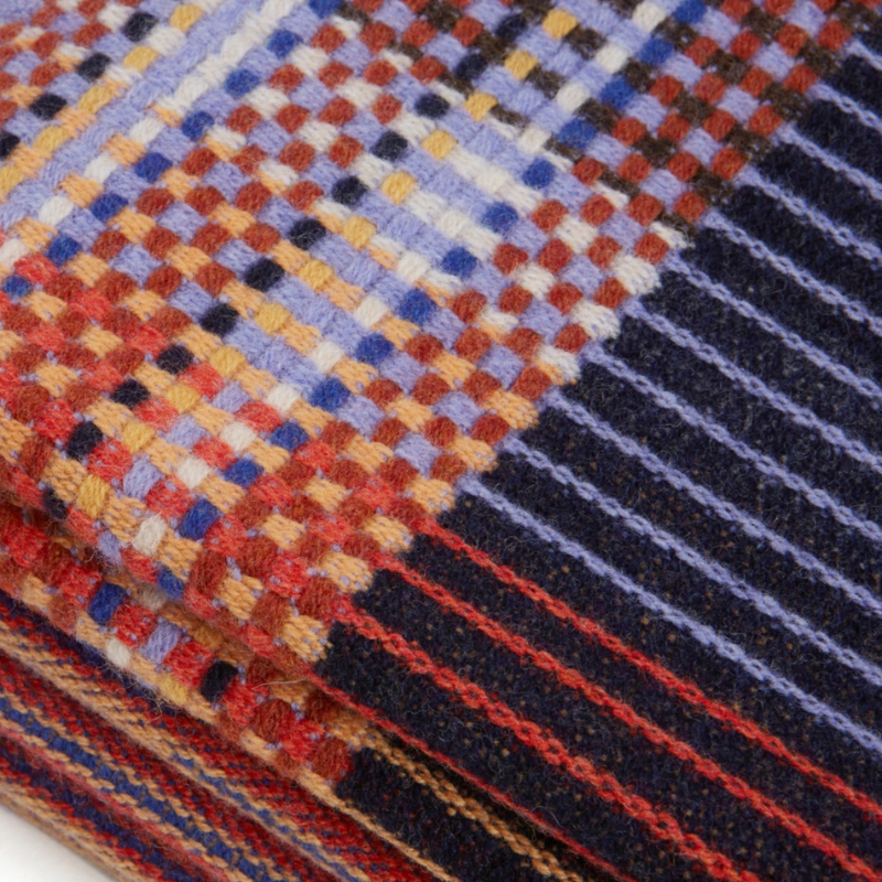 The Calvert Throw by Wallace & Sewell is made of woven merino lambswool. The Pinstripe collection combines bold-colored blocks with fine, detailed vertical stripes. This double-sided design also has a contrasting pixelated border and is a stunning room addition. Materials: 100% merino lambswool, from Australia and South Africa. Dyed and spun in Yorkshire, UK. Fabric is woven in Lancashire, UK. 
