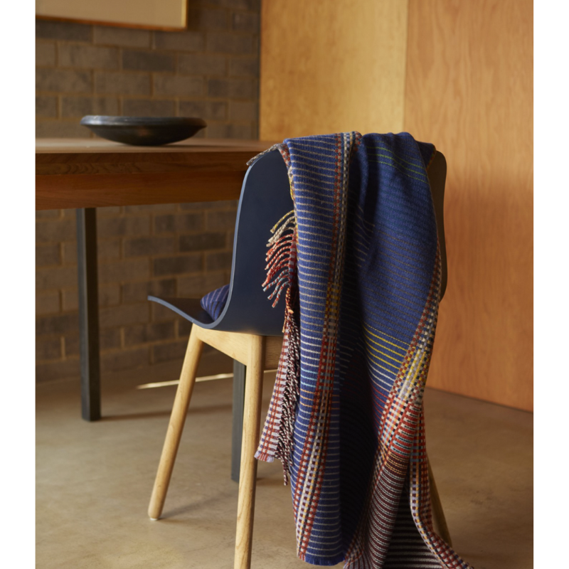 The Calvert Throw by Wallace & Sewell is made of woven merino lambswool. The Pinstripe collection combines bold-colored blocks with fine, detailed vertical stripes. This double-sided design also has a contrasting pixelated border and is a stunning room addition. Materials: 100% merino lambswool, from Australia and South Africa. Dyed and spun in Yorkshire, UK. Fabric is woven in Lancashire, UK. 