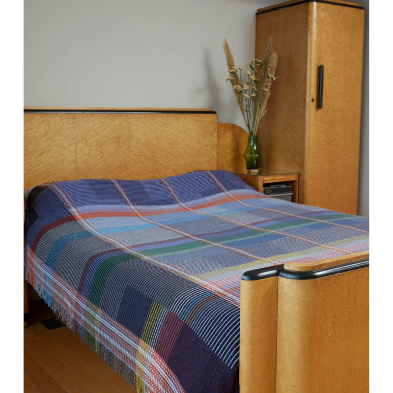 The Calvert Throw by Wallace & Sewell is made of woven merino lambswool. The Pinstripe collection combines bold-colored blocks with fine, detailed vertical stripes. This double-sided design also has a contrasting pixelated border and is a stunning room addition. Materials: 100% merino lambswool, from Australia and South Africa. Dyed and spun in Yorkshire, UK. Fabric is woven in Lancashire, UK. 