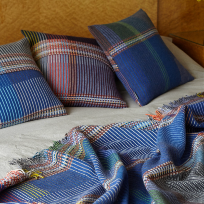 The Calvert Throw by Wallace & Sewell is made of woven merino lambswool. The Pinstripe collection combines bold-colored blocks with fine, detailed vertical stripes. This double-sided design also has a contrasting pixelated border and is a stunning room addition. Materials: 100% merino lambswool, from Australia and South Africa. Dyed and spun in Yorkshire, UK. Fabric is woven in Lancashire, UK. 