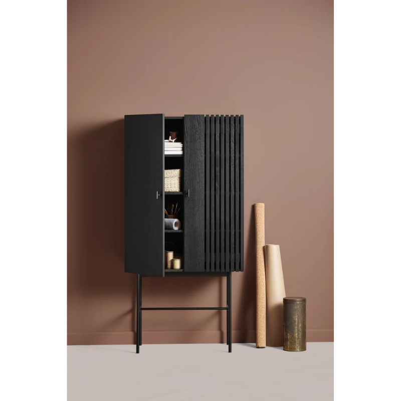 The Array Highboard from Woud in black within a living room lifestyle shot.