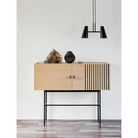 The small Array Sideboard from Woud in white pigmented oak being used for decor and storage.