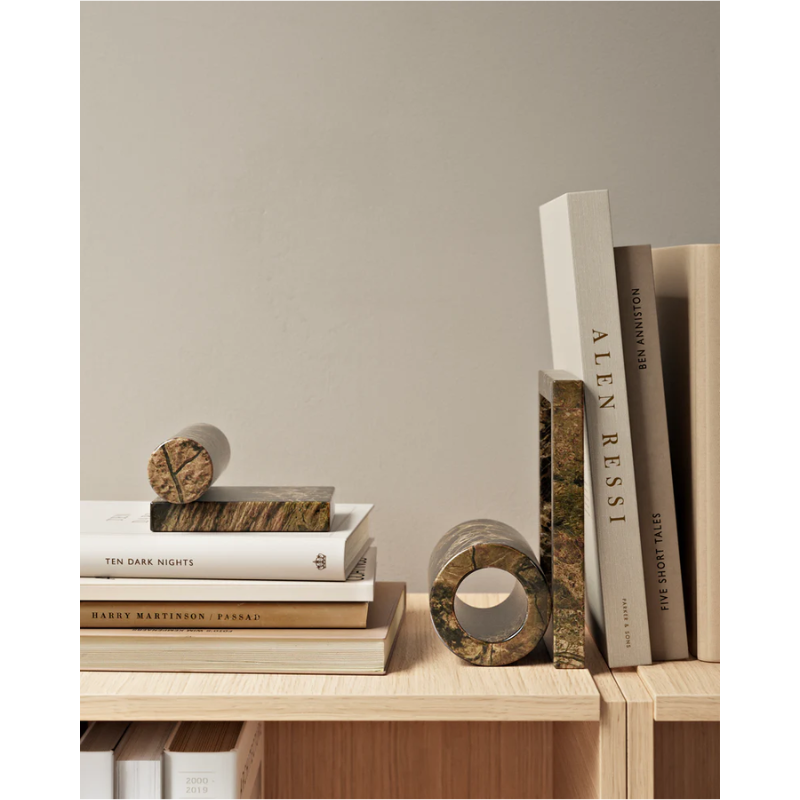 The Booknd from Woud, a solid marble bookend, being used with books.