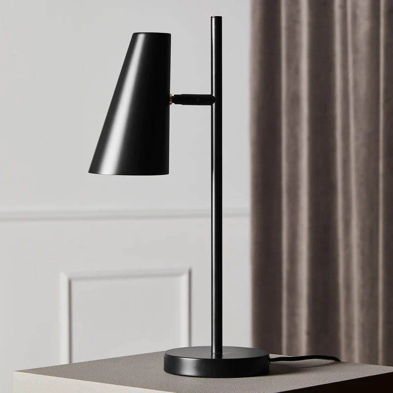 The Cono Table Lamp from Woud in a home office.