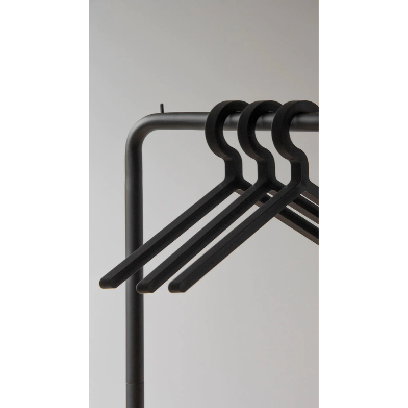 The Illusion Hanger from Woud on a clothes rack.