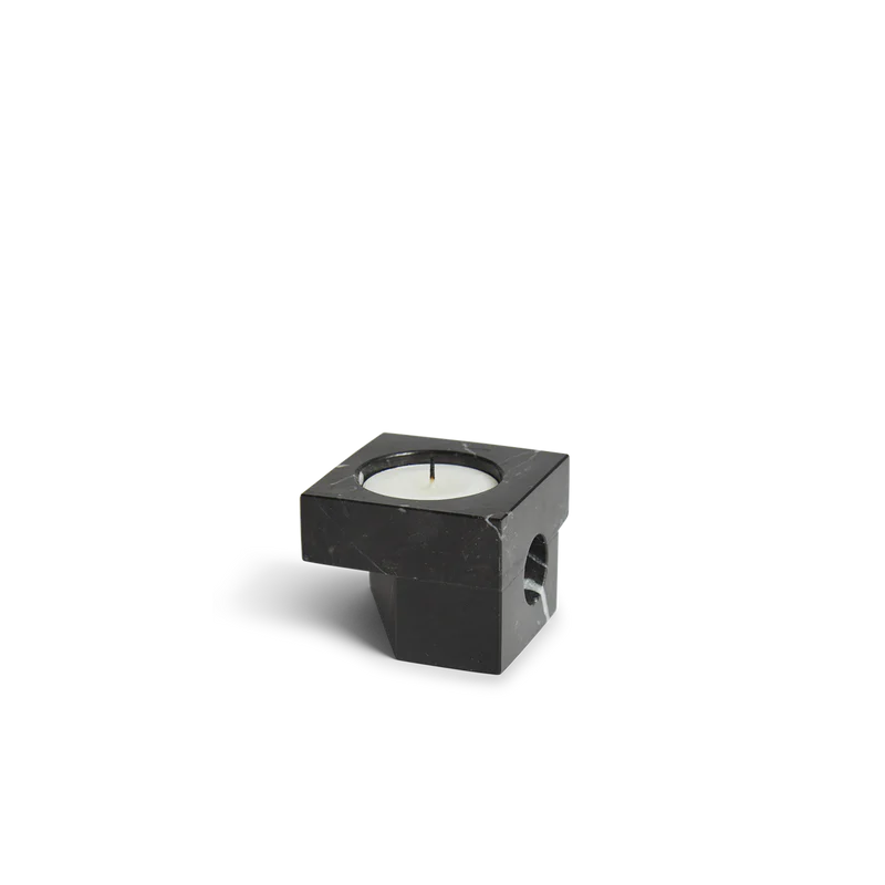 A photograph of the solid marble Jeu De Dés 2 Candle Holder by Woud in black.