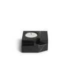 The Jeu De Dés 3 Candle Holder from Woud, made from solid marble with a tea light, in black.