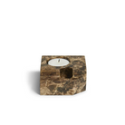 The Jeu De Dés 3 Candle Holder from Woud, made from solid marble with a tea light, in brown.