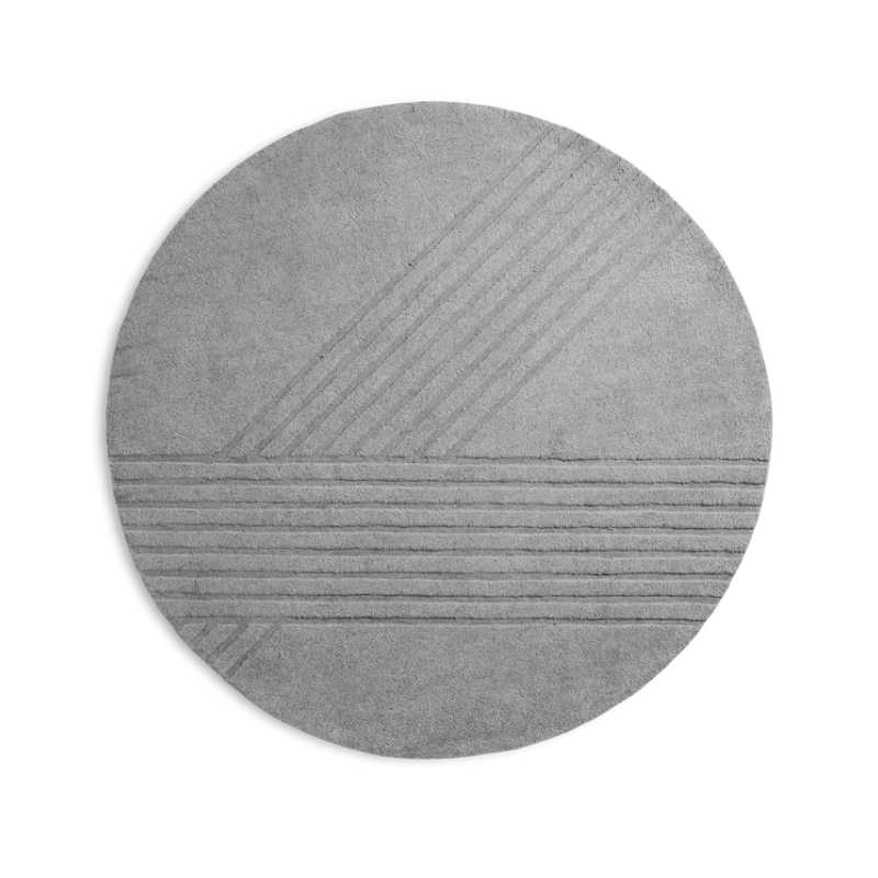 The Kyoto Rug by Woud which consists of 80% wool and 20% cotton. This is the grey color in the 200cm circle size.