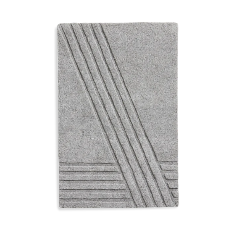 The Kyoto Rug by Woud which consists of 80% wool and 20% cotton. This is the grey color in 90 x 140 (cm) size.