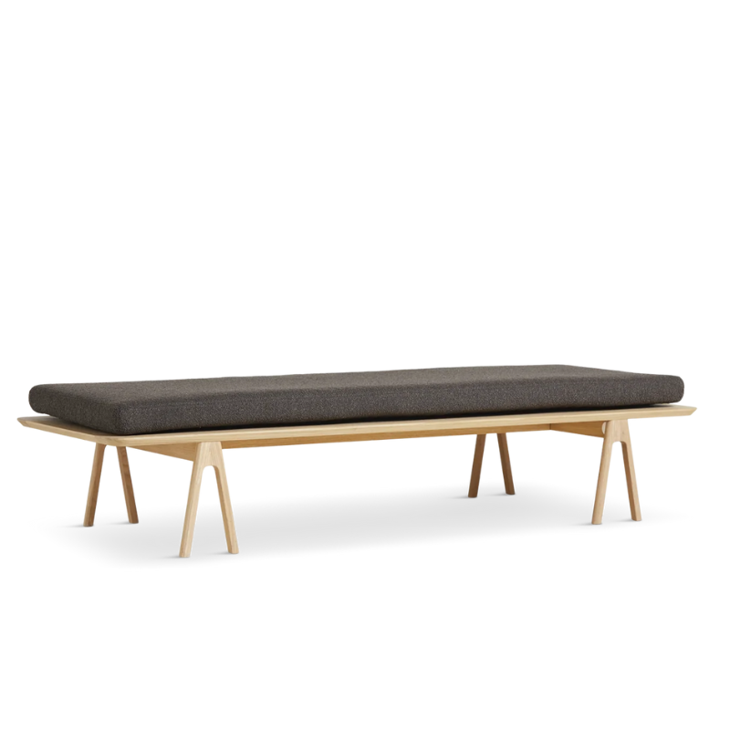 The Level Daybed from Woud with Dark Brown Bouclé cushion and oak frame.