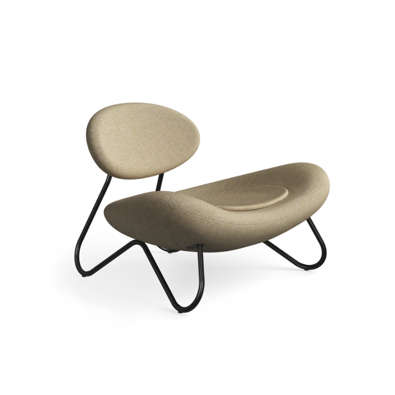 The Meadow Lounge Chair from Woud with beige fabric and black legs.