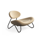 The Meadow Lounge Chair from Woud with gold leather and black legs.