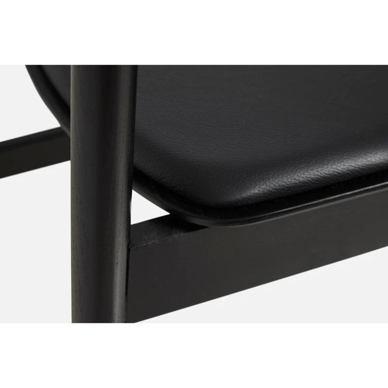 A close up on the Pause Dining Chair 2.0 from Woud in Black with Leather.