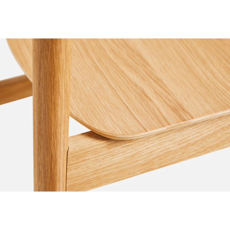 A close up on the Pause Dining Chair 2.0 from Woud in Oiled Oak