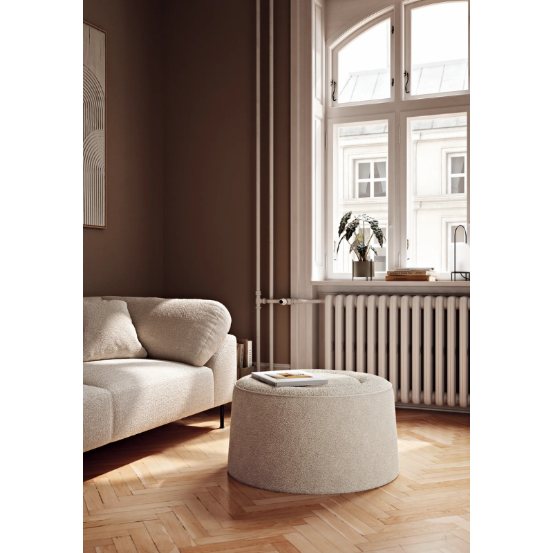 The Praline Pouf from Woud in a lounge space.
