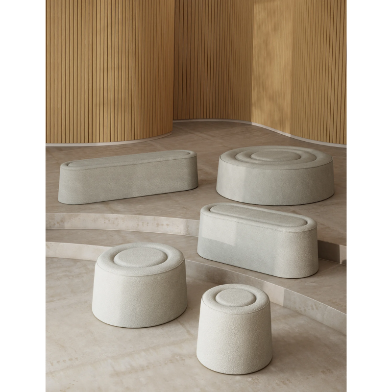 The Praline Pouf from Woud in a lifestyle shot showing all three pouf sizes and the two bench sizes.