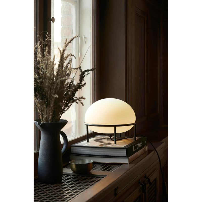 The Pump Table Lamp from Woud in a bedroom lifestyle photograph.
