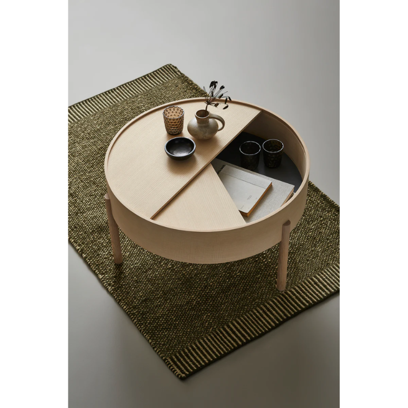 The Rombo Rug from Woud in a family room underneath a coffee table.
