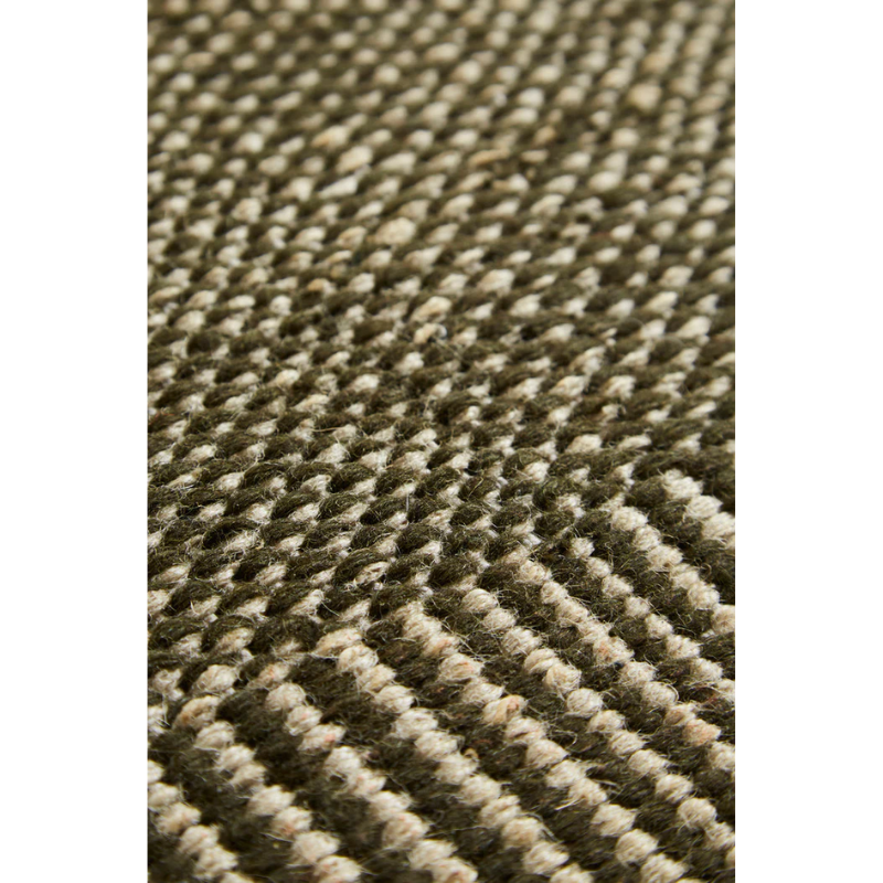 A close up on the moss green fabric of the Rombo Rug.