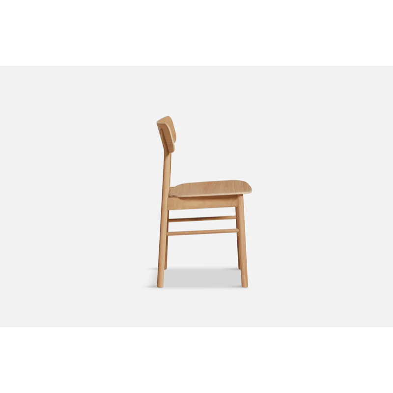 The Soma Dining Chair from Woud in Oiled Oak from the side.