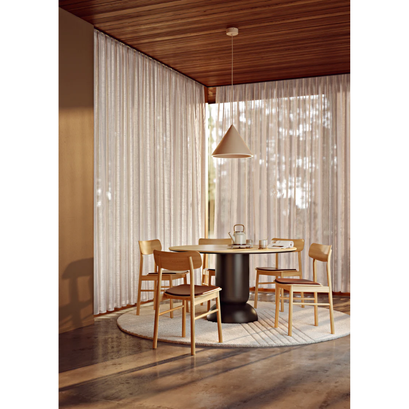 The Soma Dining Chair from Woud in Oiled Oak with Leather set up as a group of four around a table.