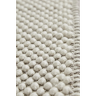 A close up on the fabric used for the Tact Rug from Woud in off white color.