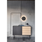 The Virka Sideboard (high) from Woud underneath a light among other decor.