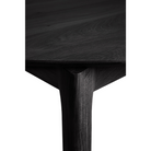 The Round Bok Extendable Dining Table from Ethnicraft in solid oak, tainted black.