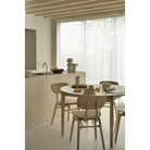 The Round Bok Extendable Dining Table from Ethnicraft in a dining room.