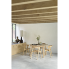 The Round Bok Extendable Dining Table from Ethnicraft in a family space.