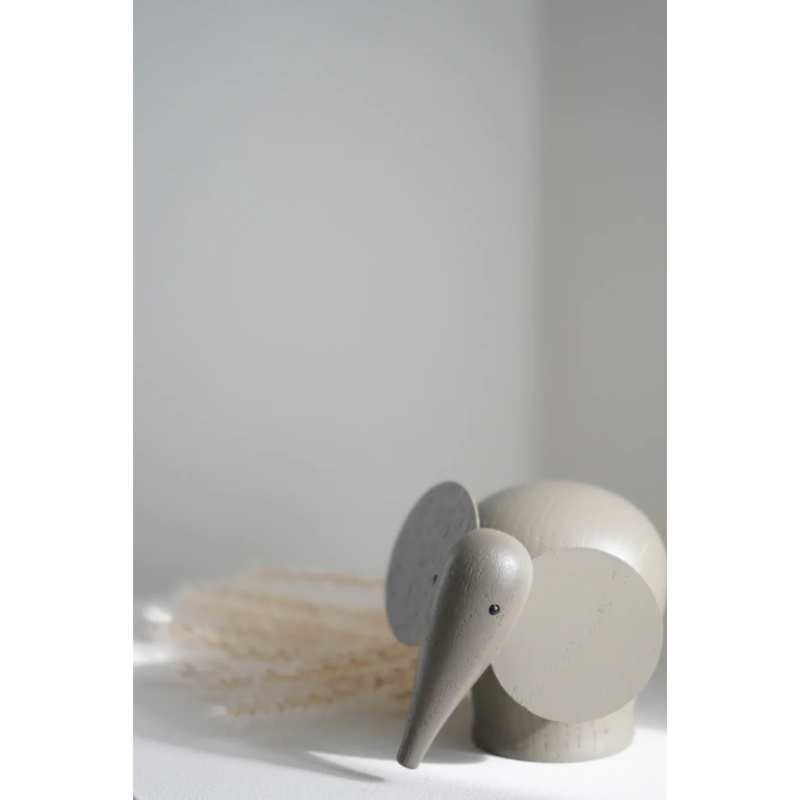 The solid oak Nunu Elephant from Woud painted taupe in a close up shot.