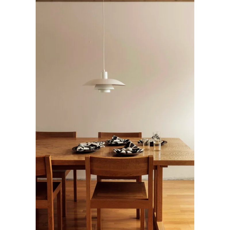 The PH 4/3 Metal Pendant was launched in 1966. Its design follows the general three-shade system based on the logarithmic spiral, with the center of the light source positioned at the axis of the spiral. 
