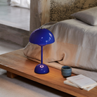 &Tradition VP9 Flowerpot Portable Table Lamp in cobalt blue being used as reading light