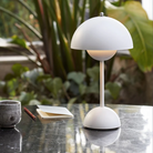 &Tradition VP9 Flowerpot Portable Table Lamp in matte white on a table.