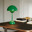 &Tradition VP9 Flowerpot Portable Table Lamp in signal green being used on a desk with no outlets nearby.
