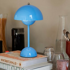 &Tradition VP9 Flowerpot Portable Table Lamp in Swim Blue on kitchen counter.