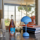 &Tradition VP9 Flowerpot Portable Table Lamp in Swim Blue being used to provide mood lighting.