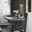 The Come Together Portable Lamp from Artemide in aluminum in a dining room.