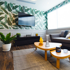 The Come Together Portable Lamp from Artemide in white in a lounge.