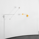 The antracite gray Ixa Arm Plug In Wall Sconce from Artemide in a living room. all-groups