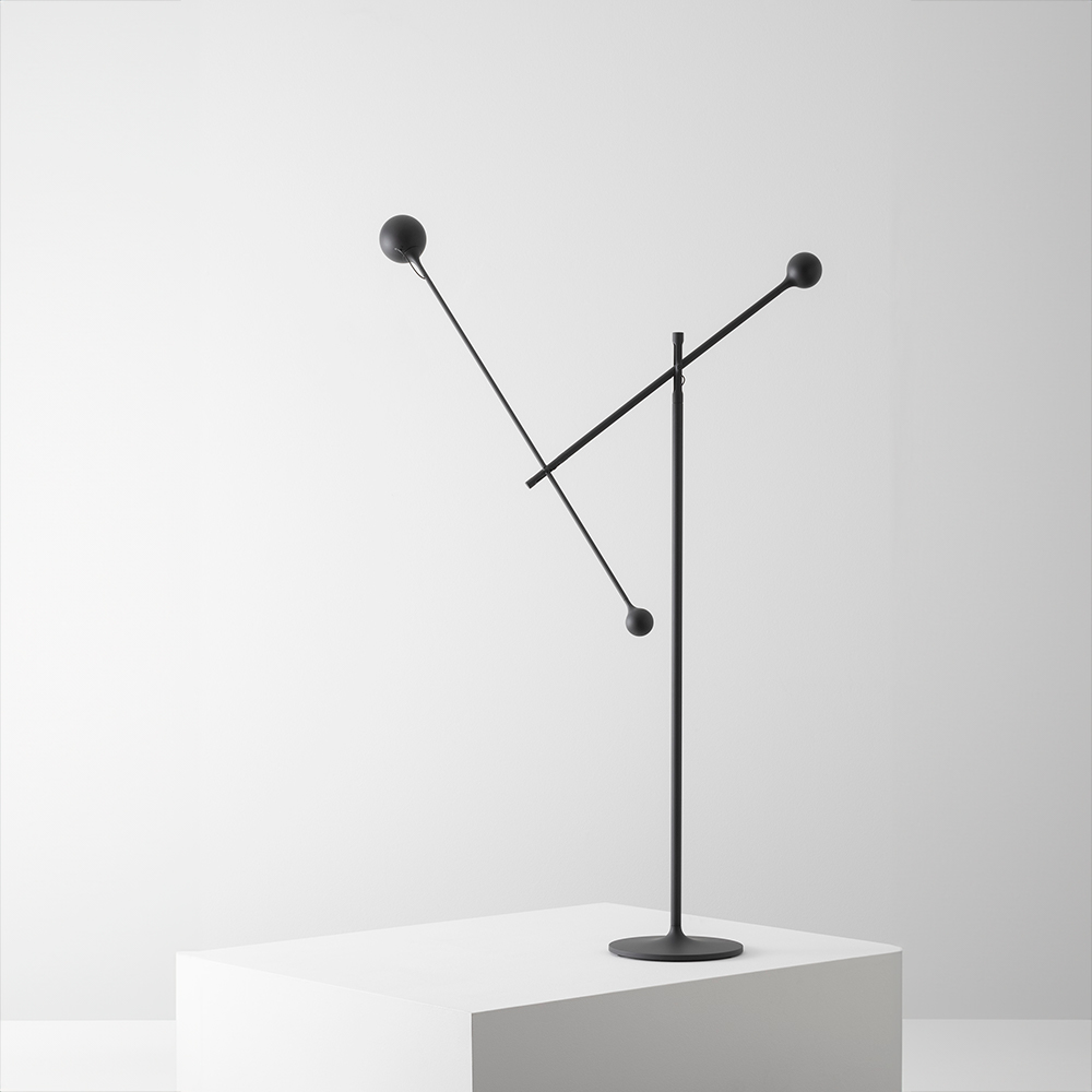 The anthracite gray Ixa Classic Floor Lamp from Artemide in a home office.