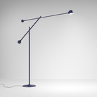 The blue Ixa Classic Floor Lamp from Artemide in a family area.