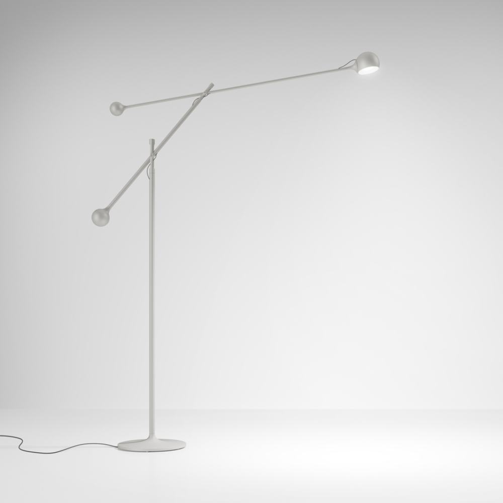 The white Ixa Classic Floor Lamp from Artemide in a business space.