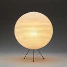 The Mari Lamp - A122 from Asano, a small table lamp turned on.