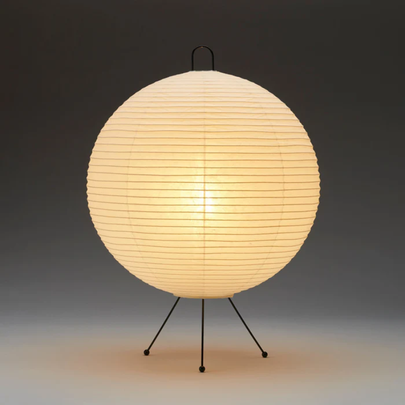 The Mari Lamp - A122 from Asano, a small table lamp turned on.