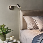 The bronze Ascoli Swing Reading Light from Astro Lighting in a primary bedroom.