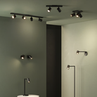 The matte black Ascoli Swing Reading Light from Astro Lighting in a living room.